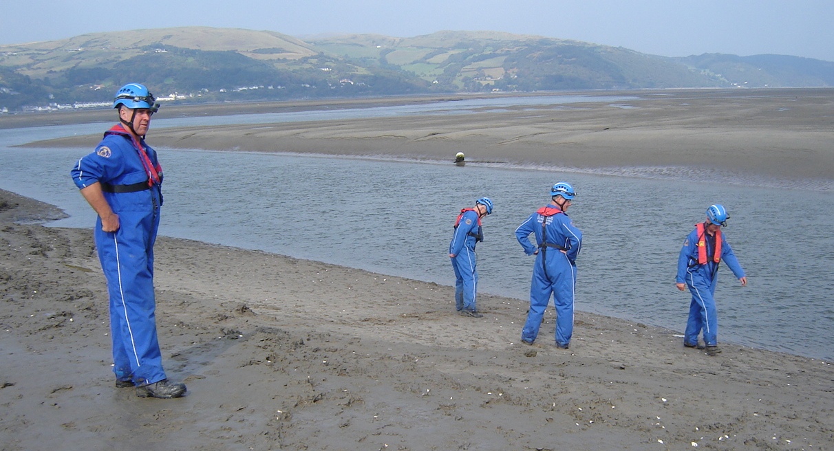 Coast Guard officers inspecting ordinance found on the beach